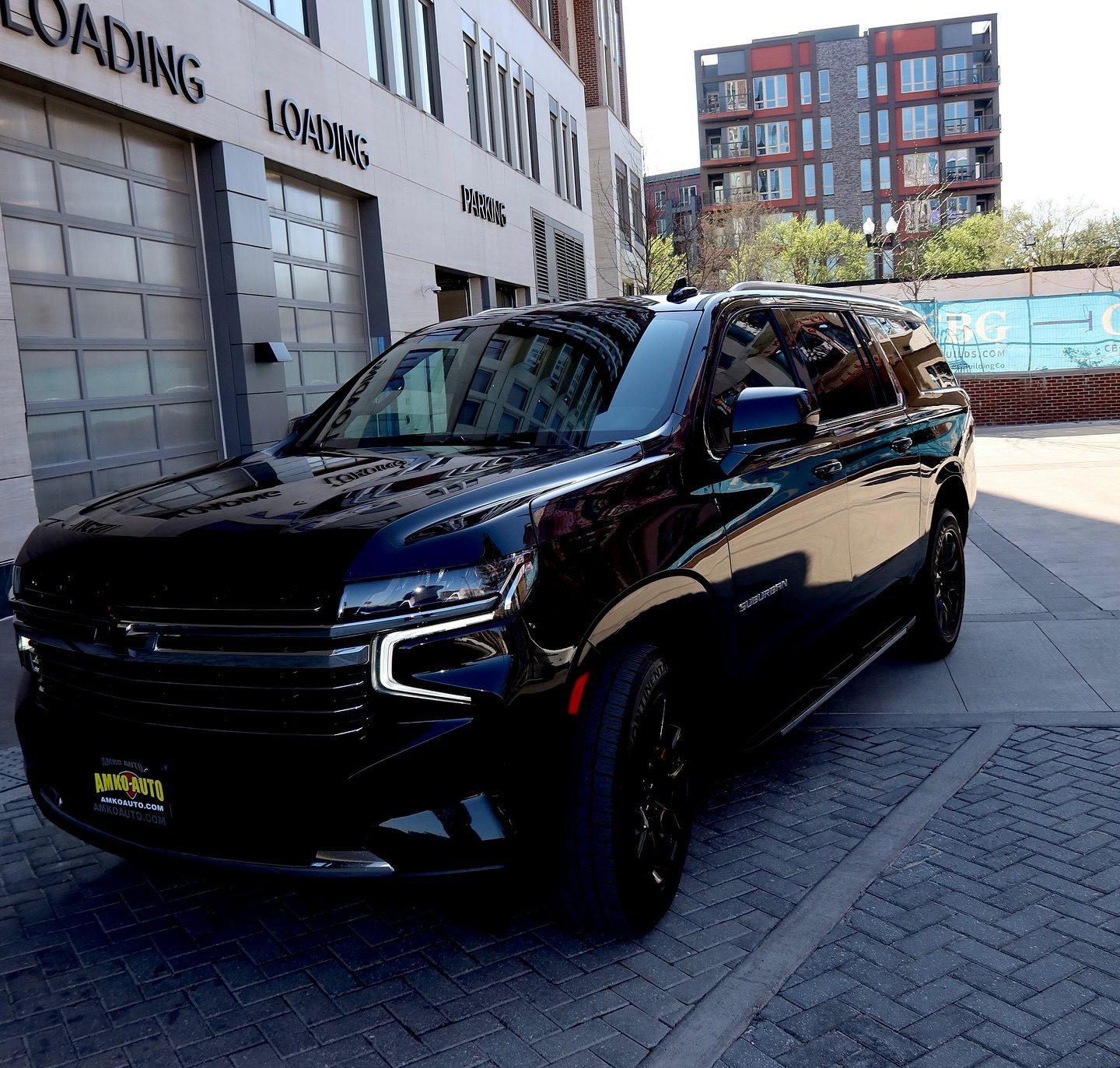 Black Chevrolet Suburban, front three-quarter view